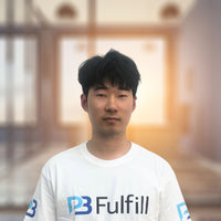 Person wearing a white t-shirt with a logo in an indoor setting.