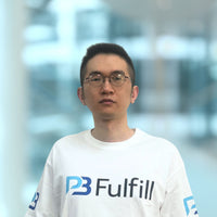 Person wearing a white shirt with a logo in an indoor setting