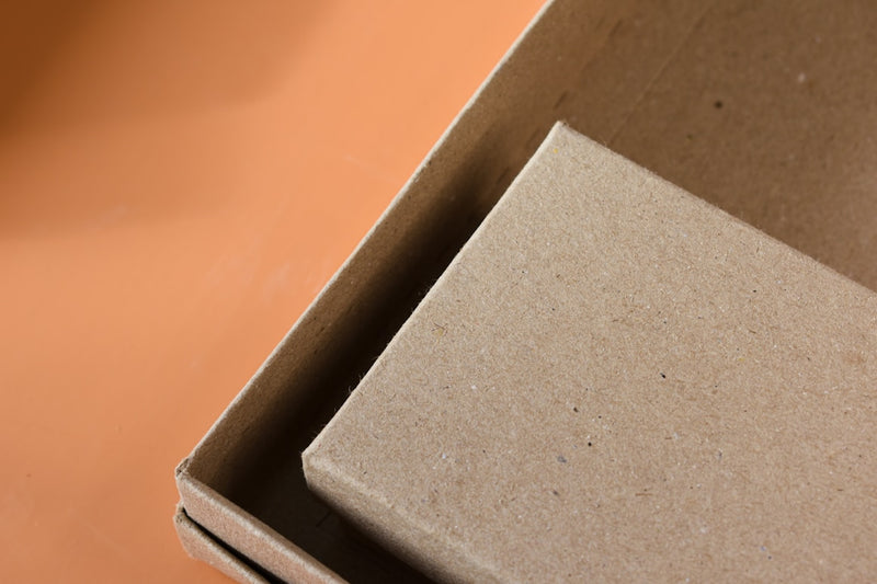 Close-up of a brown cardboard box corner on a brown background